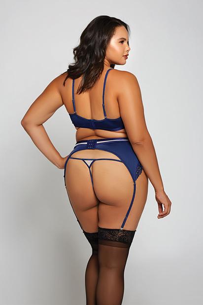 Model with her back to camera is wearing a navy blue waist cincher with matching bra and g string